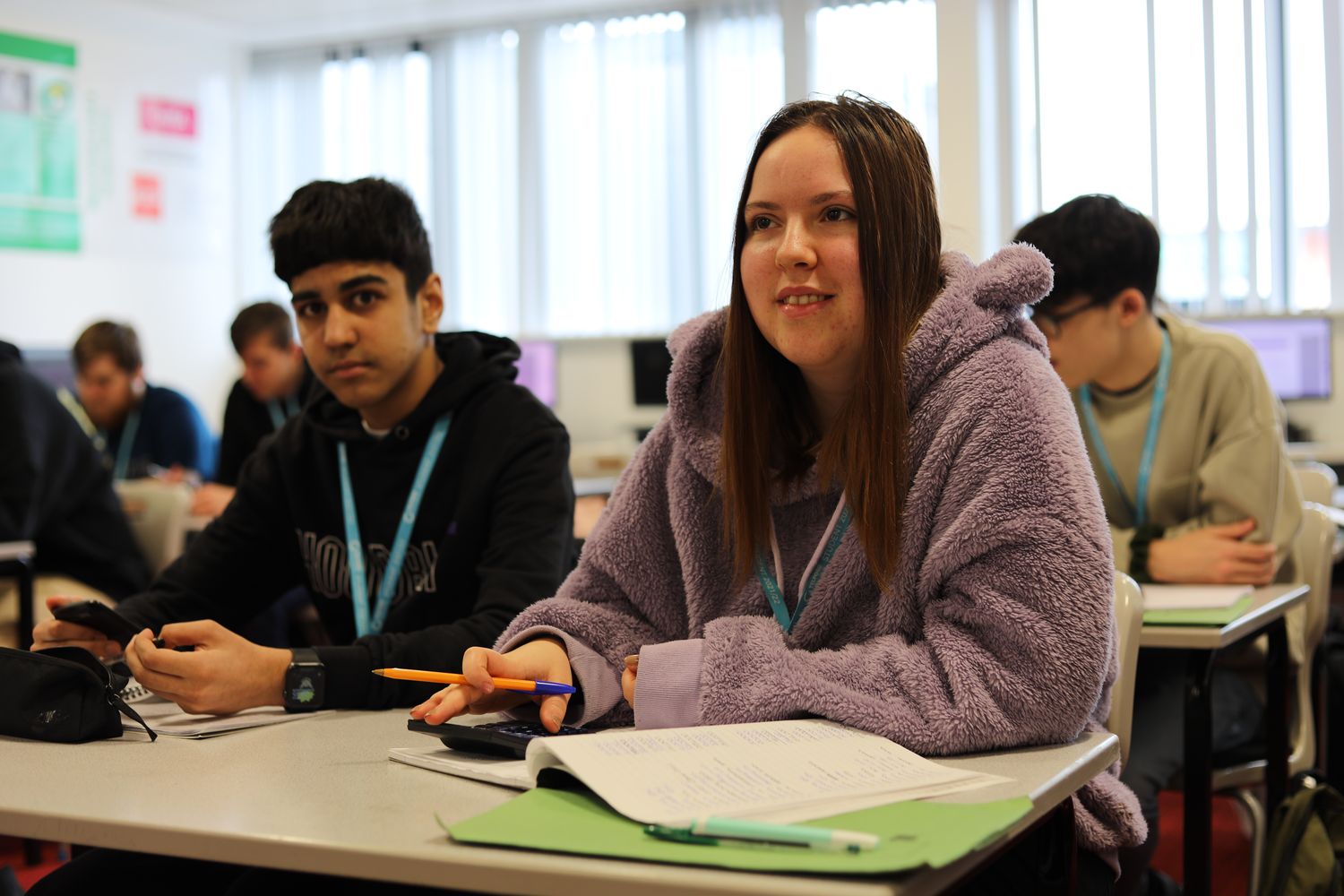 male and female accounting student at desk