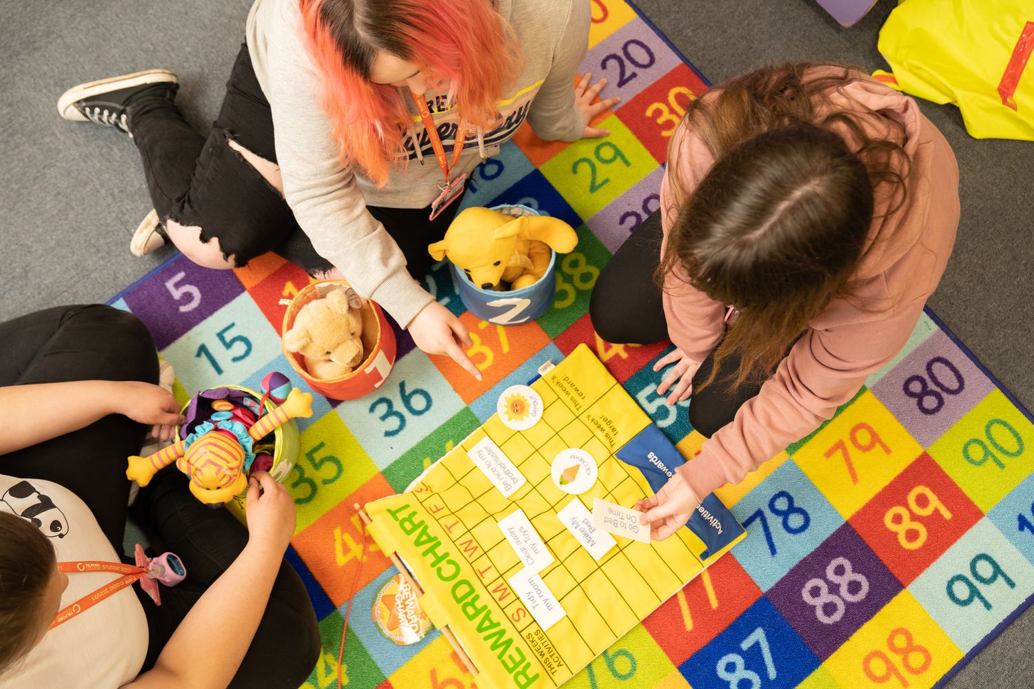 children playing with education students