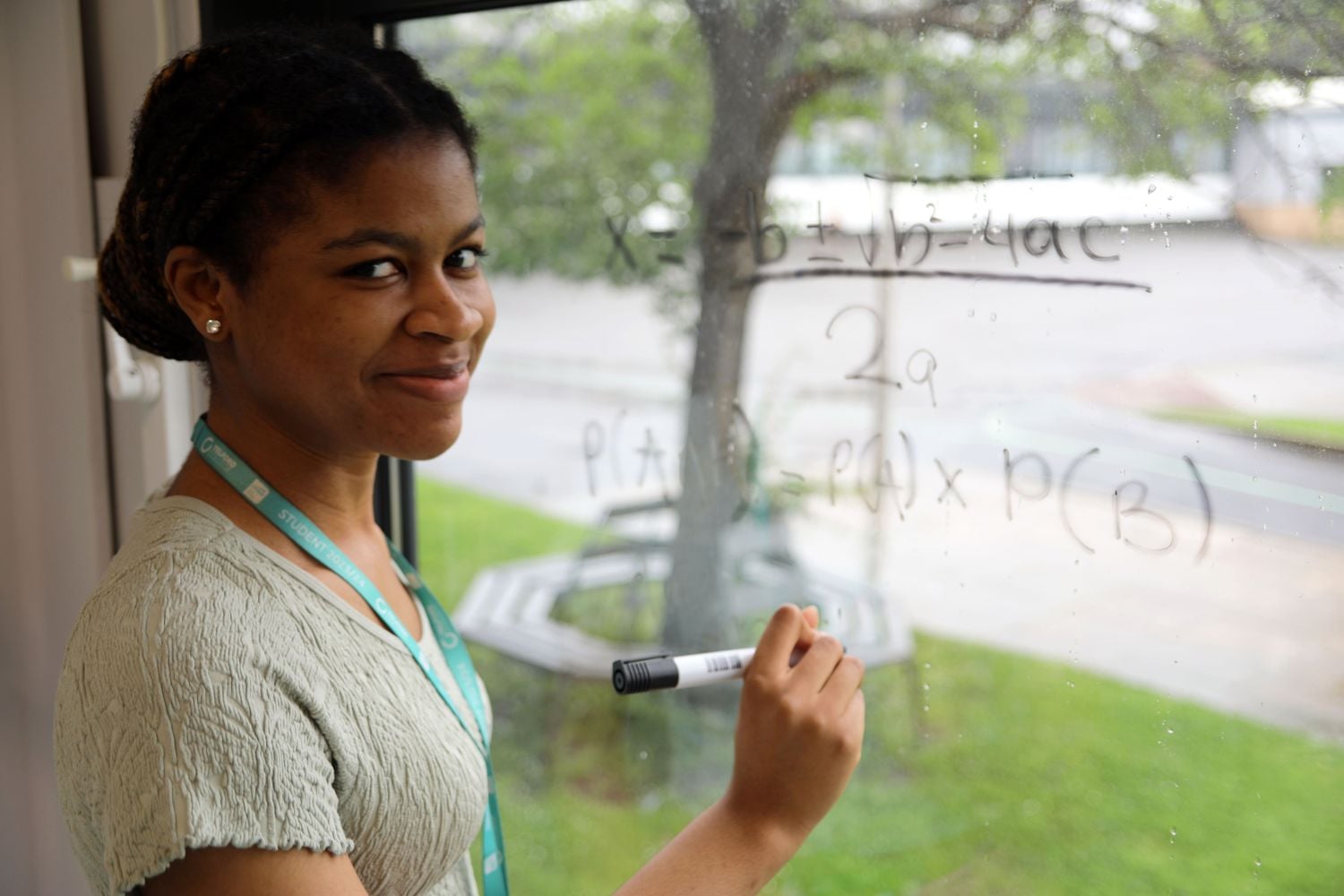 Favour, a level student writing on window