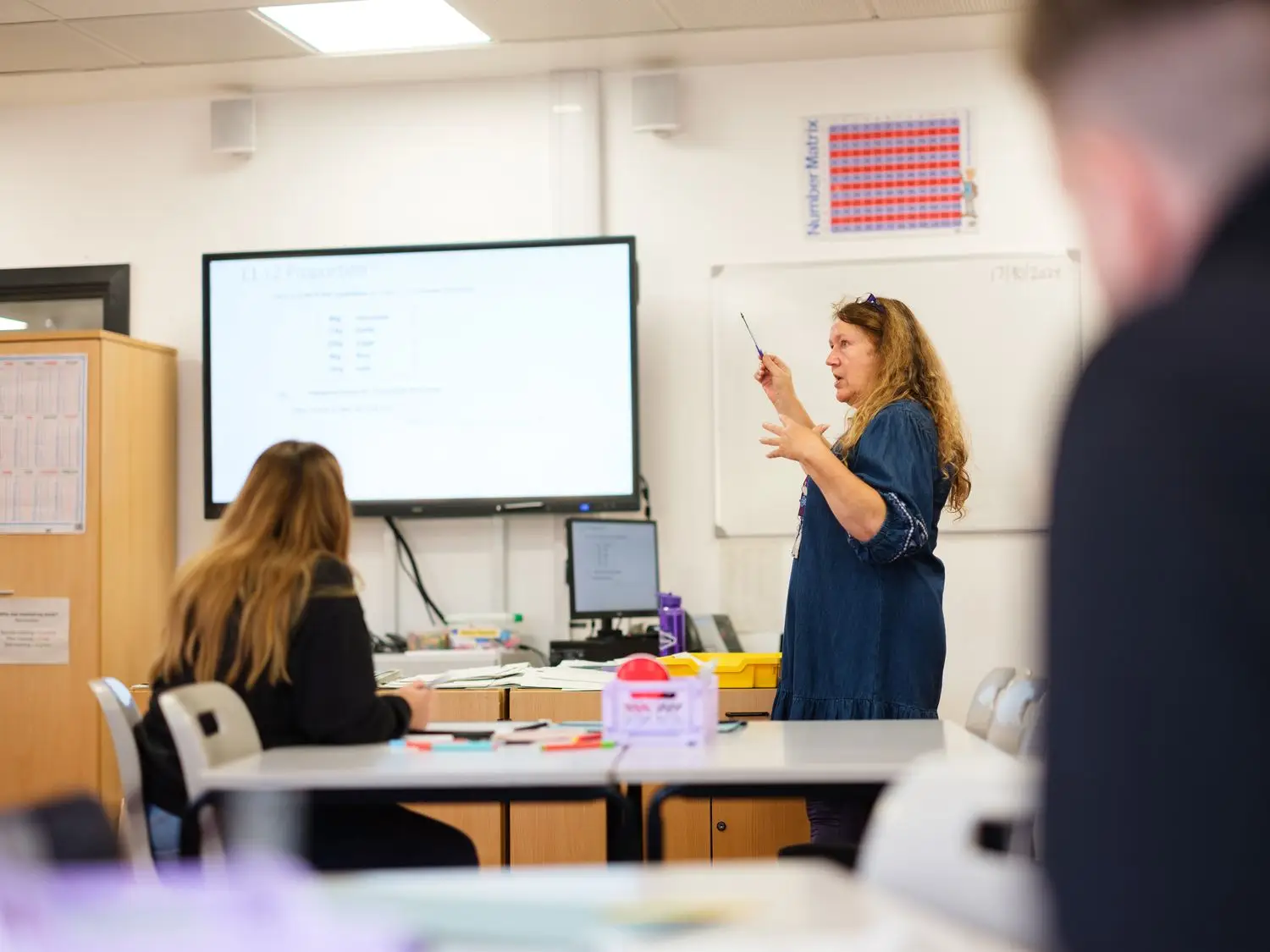 Maths & English student and tutor in classroom