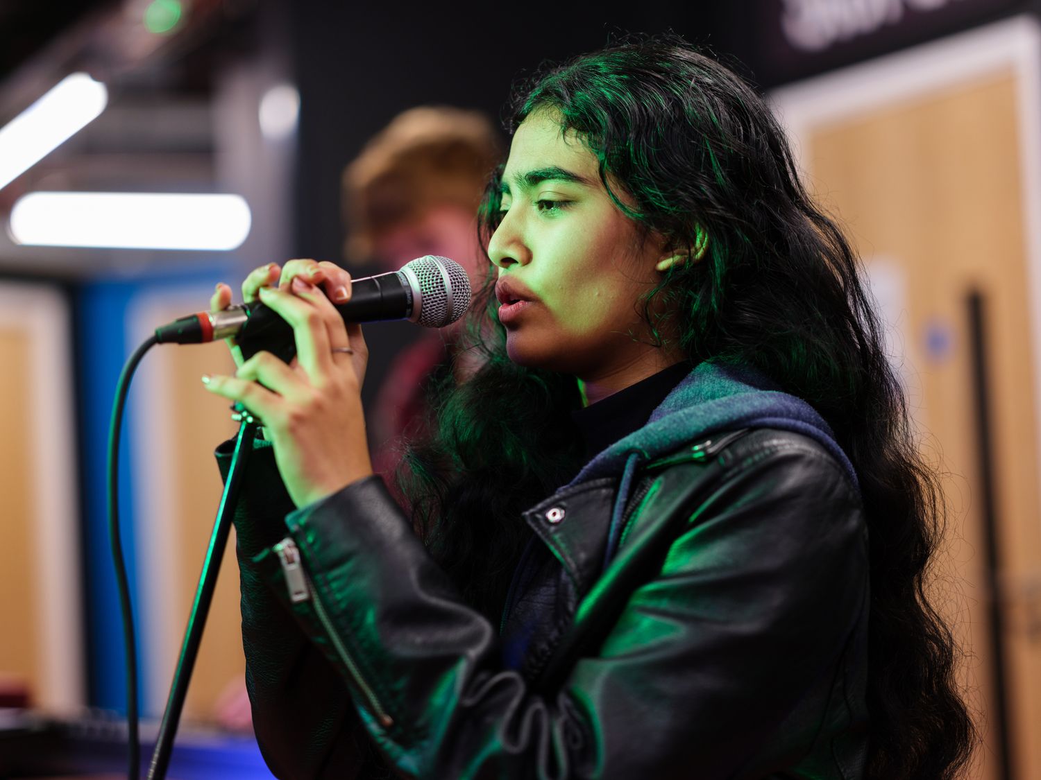 student singing into microphone