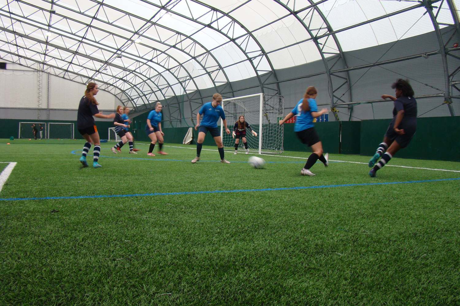 sport students playing football on field