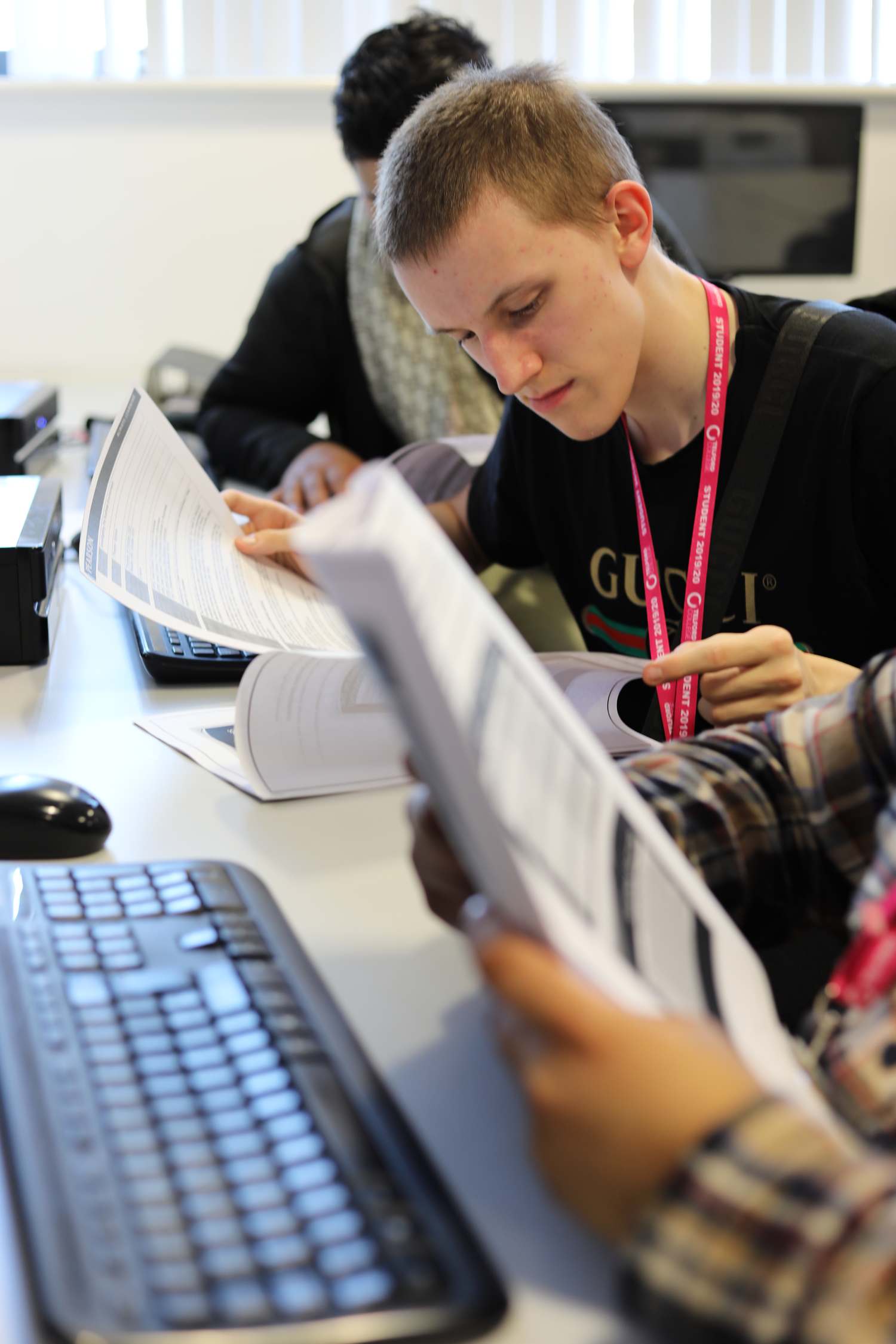 business student sat at desk in classroom