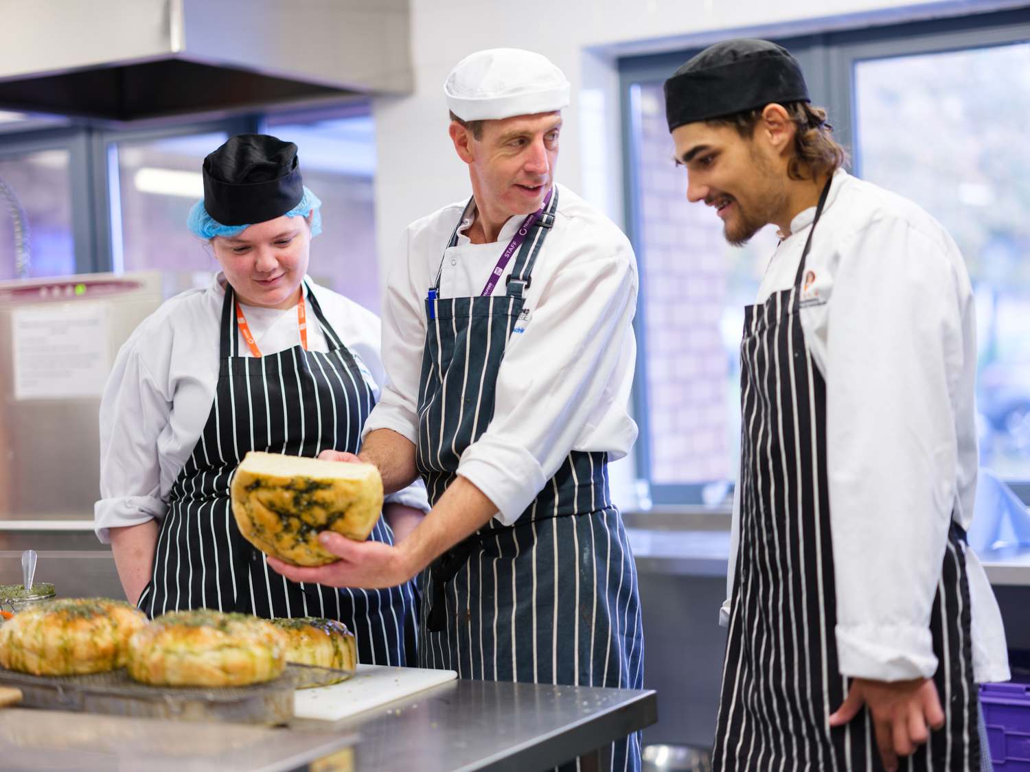 catering students in kitchen preparing food
