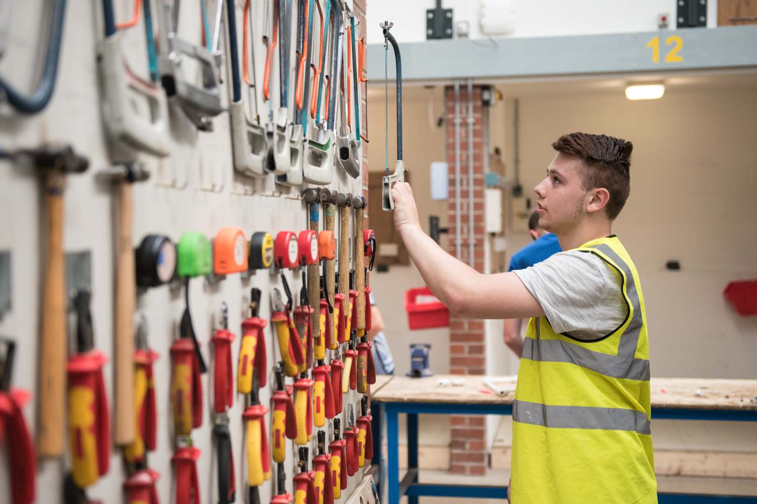 apprentice student with tool wall