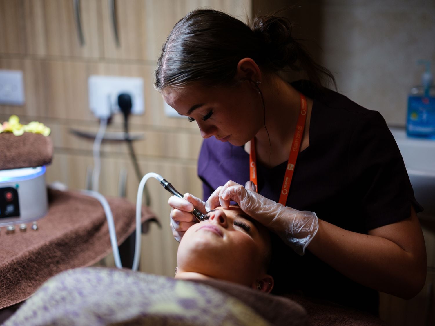 hair and beauty student in the retreat doing eyebrows