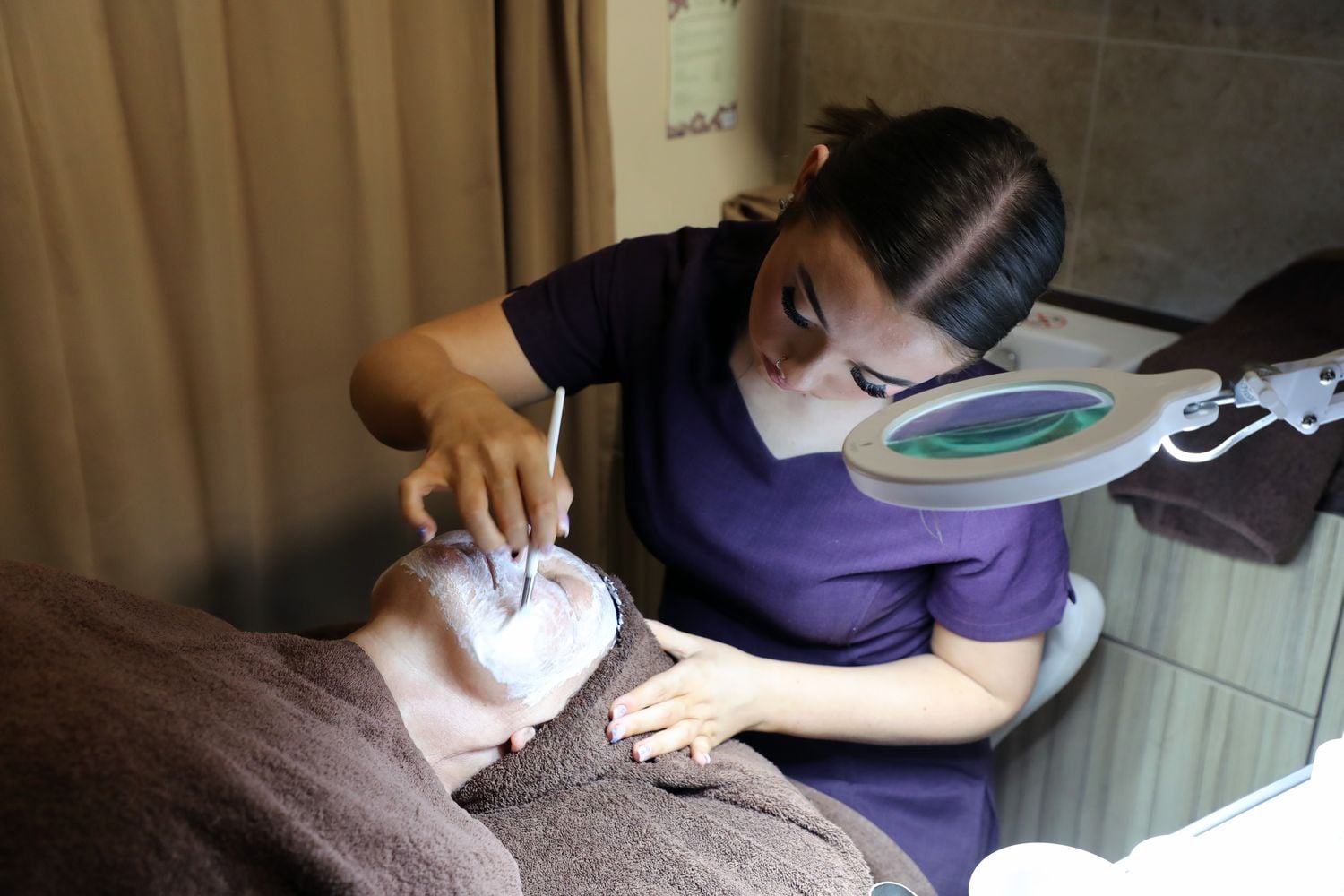 hair and beauty student in the retreat doing a facial