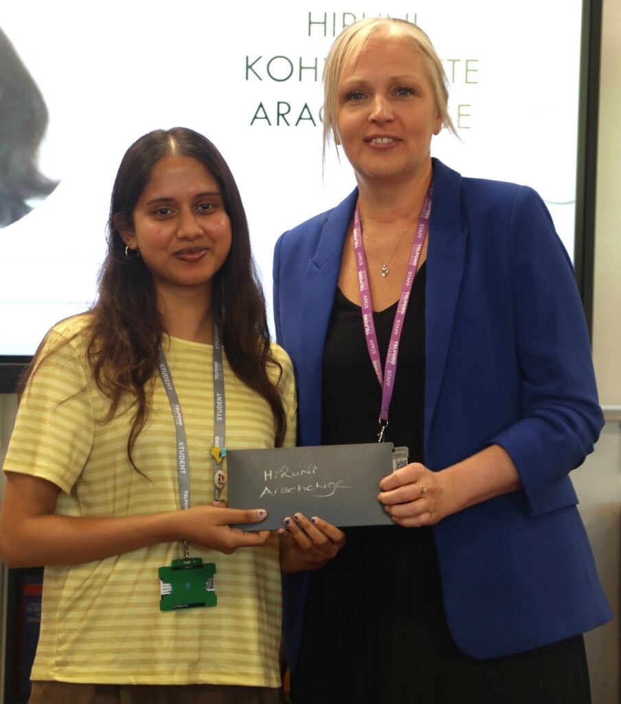 Hiruni receives her first prize from vice principal Caroline Bastow
