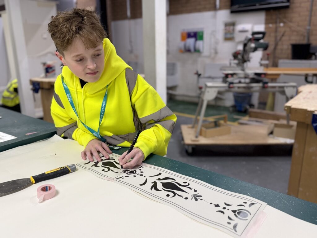 TADLOP production of Frozen - construction students at work on building sets