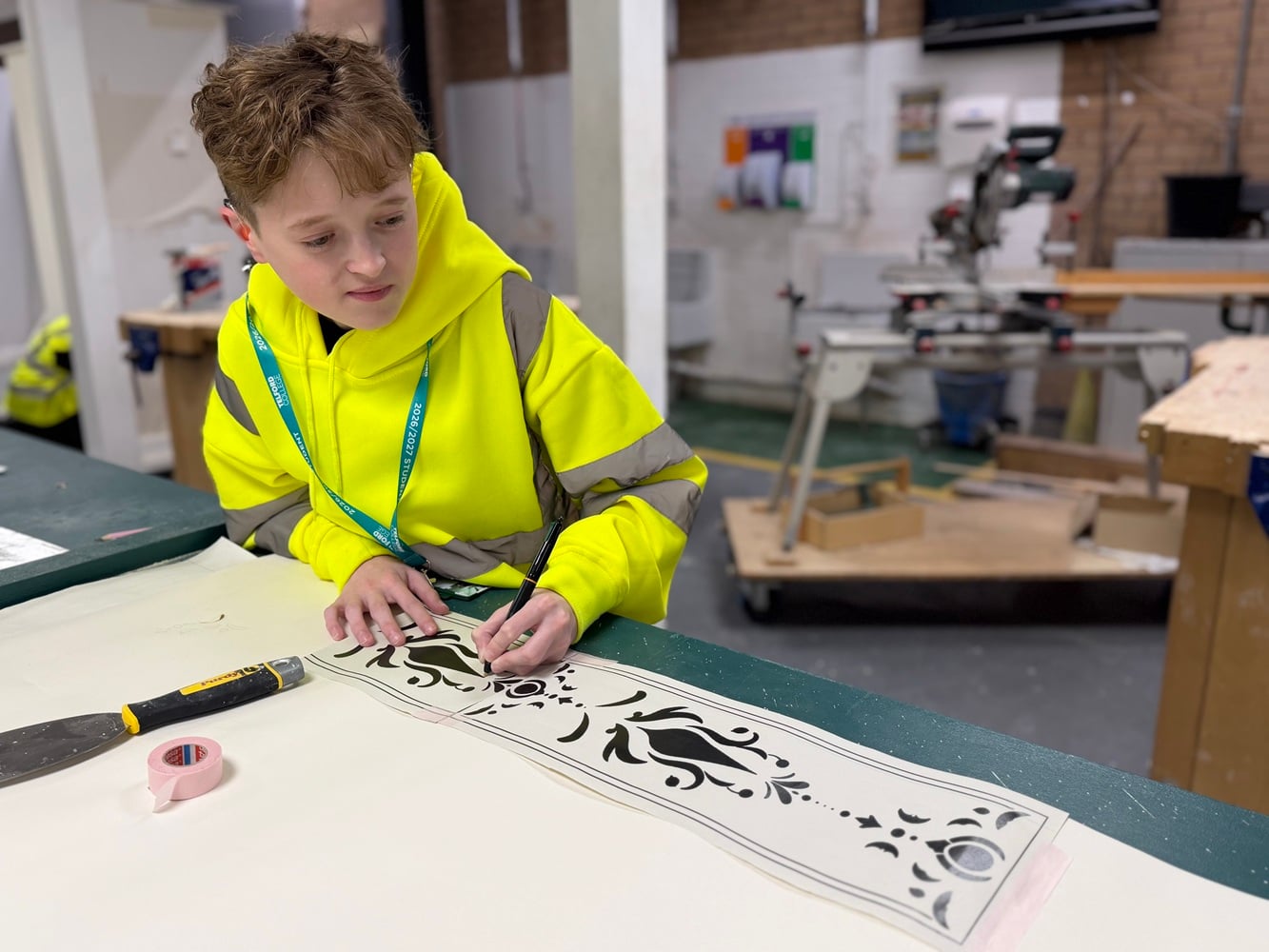 TADLOP production of Frozen - construction students at work on building sets